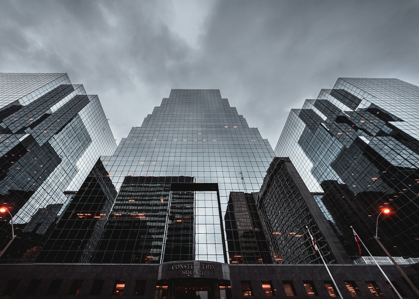 Glass towers at dusk, seen from street level